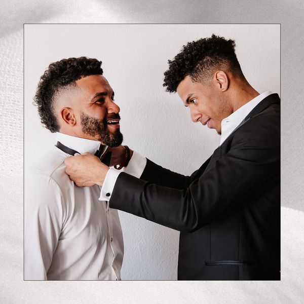 Best Man Tying Groom's Bow Tie on Wedding Morning