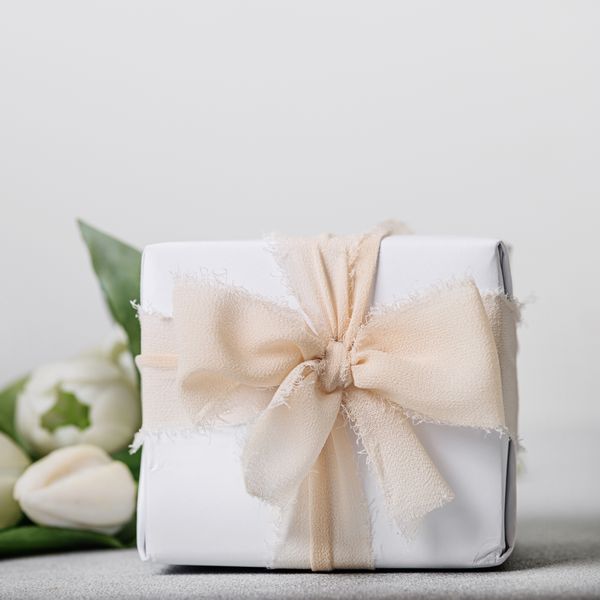 wrapped white box with white tulips