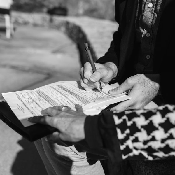 man signing a marriage certificate