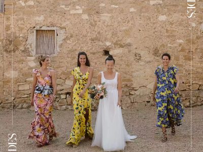 a bride and her bridesmaids who are wearing colorful printed dresses