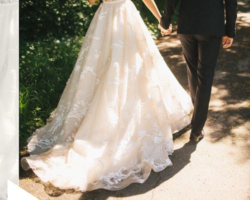 Bride in White Wedding Dress Holding Hands With Groom in Black Tuxedo