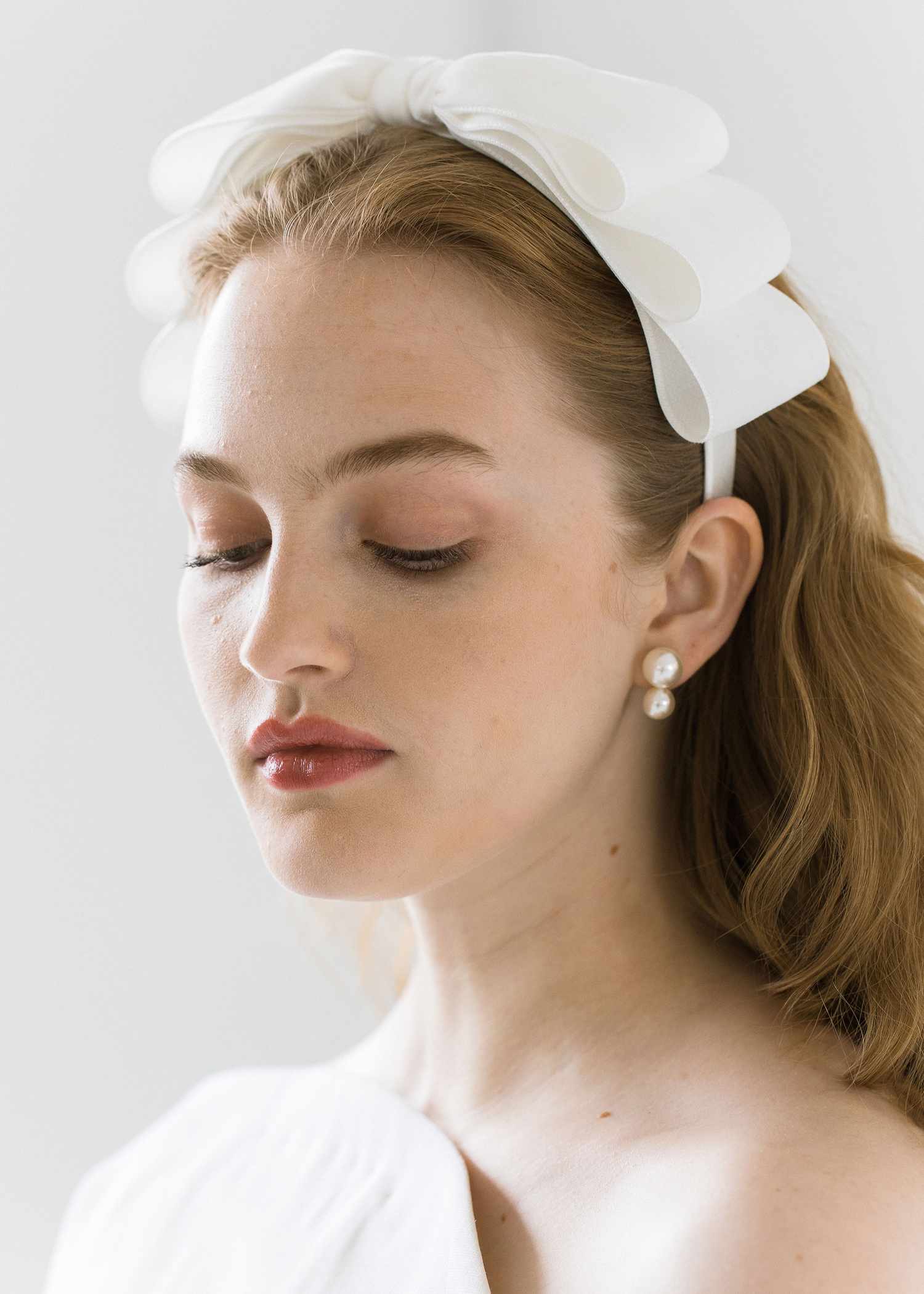 model wearing a white ruffled headband