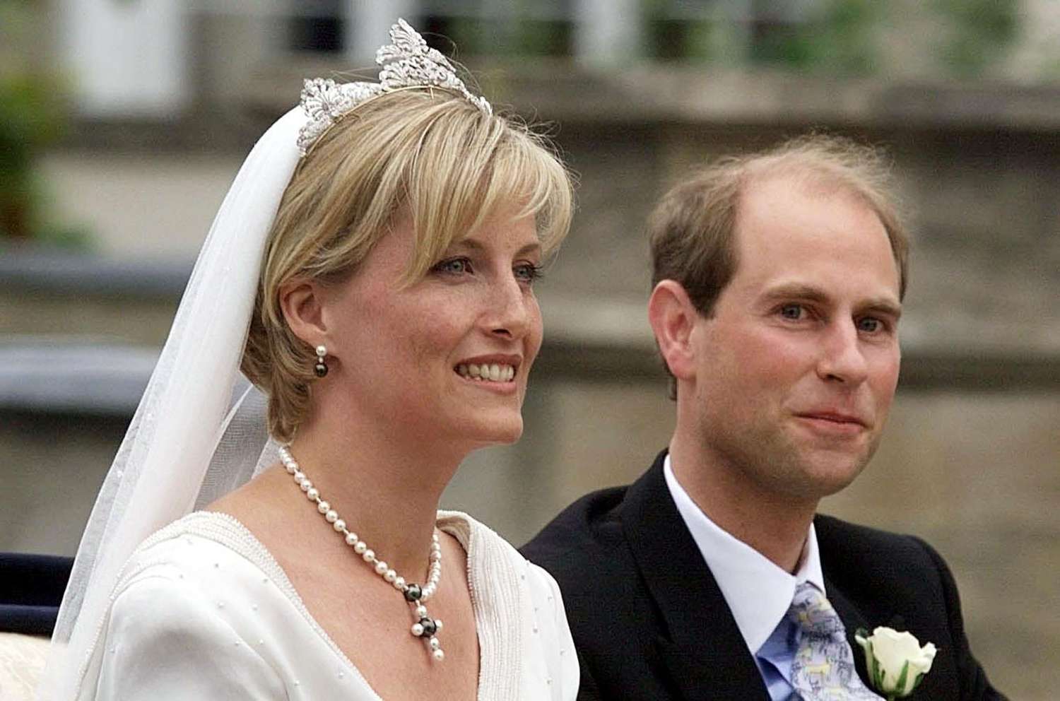 Sophie Wessex in diamond tiara, veil, pearl earrings, and pearl necklace sitting next to Prince Edward