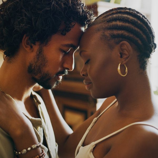 close up of young couple holding each other in living room