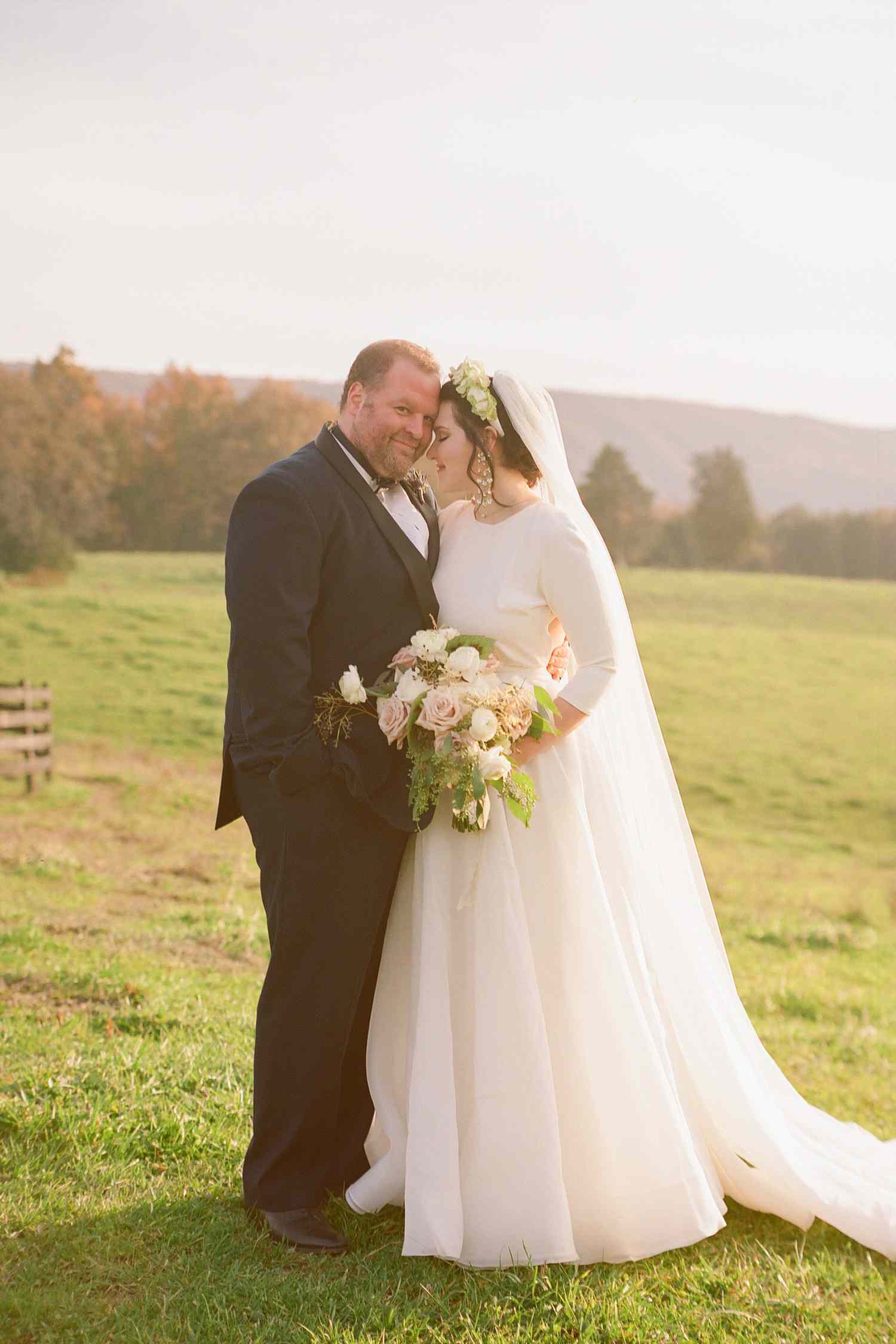 bride and groom portrait photographed in an open field 