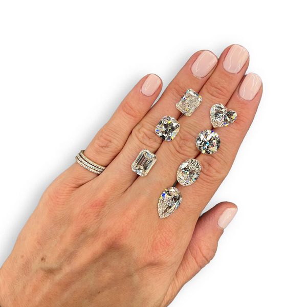 a variety of diamond shapes presented on a hand for reference