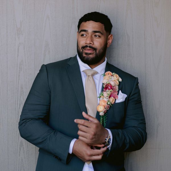 Groom in Dark Suit Jacket With Oversized Floral BoutonniÃ¨re