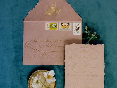 Pink Deckle-Edge Envelope with Stamps and Calligraphy and Matching Invitation on Blue Velvet Fabric