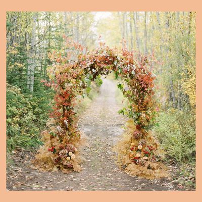 Ceremony arch made from fall-colored flowers and dried foliage