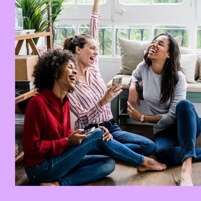 girls laughing together while sitting on floor