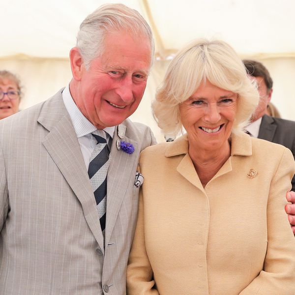 King Charles and Queen Camilla Smiling With Their Arms Around One Another