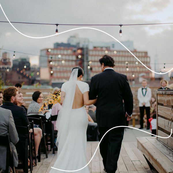 Bride and Father Walking Down the Aisle Toward Groom from Behind with City Skyline Behind