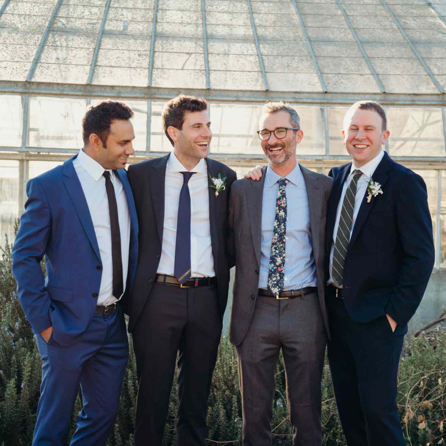 groomsmen wearing mismatched suits and accessories