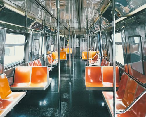 New York City Subway Car With Orange and Yellow Seats