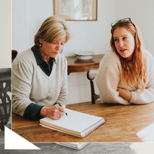 daughter talking to her mother at a dining room table