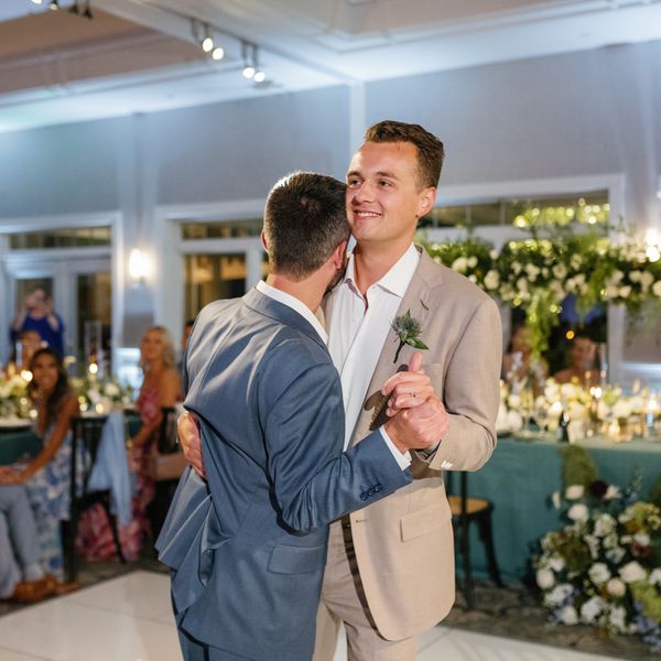 Groom in Blue Suit and Groom in Tan Suit Slow-Dancing During Wedding Reception