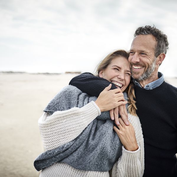 Closeup of a couple laughing on a beach