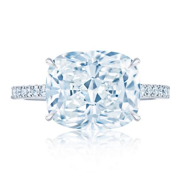solitaire diamond engagement ring set east-west and secured by tapered prongs. featuring a hidden pavÃ© halo atop a Platinum pavÃ© band