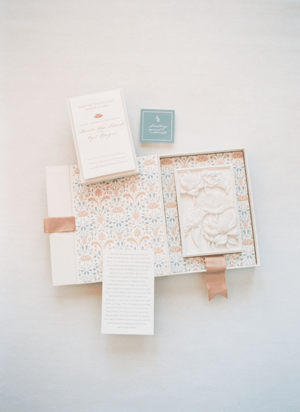 A clay boxed wedding invitation.