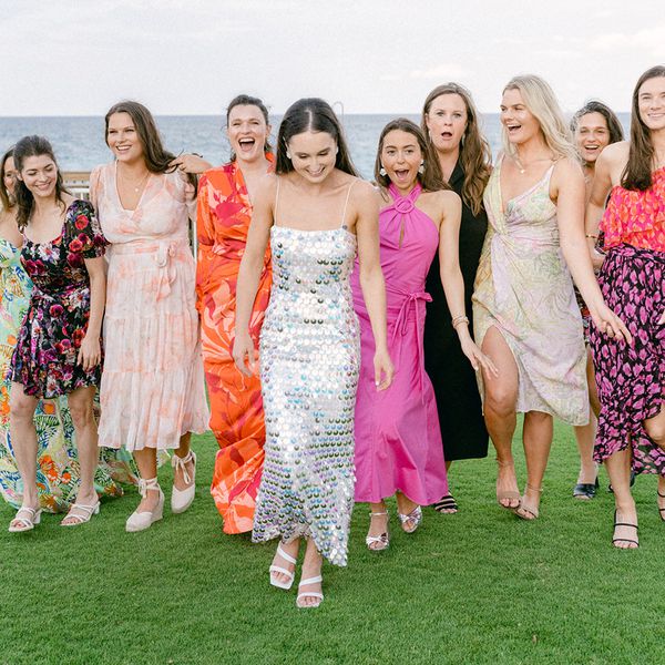 a group of women wearing colorful dresses walking and smiling