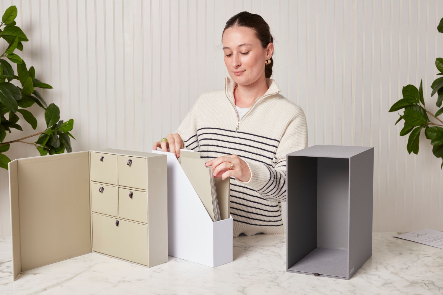 A person flipping through the Uncommon Goods Personalized Wedding Keepsake Library in Slate