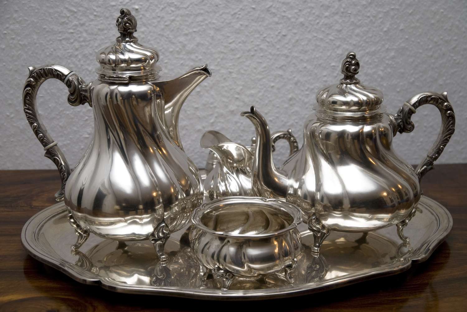 Two silver teapots and one silver dish on a silver platter