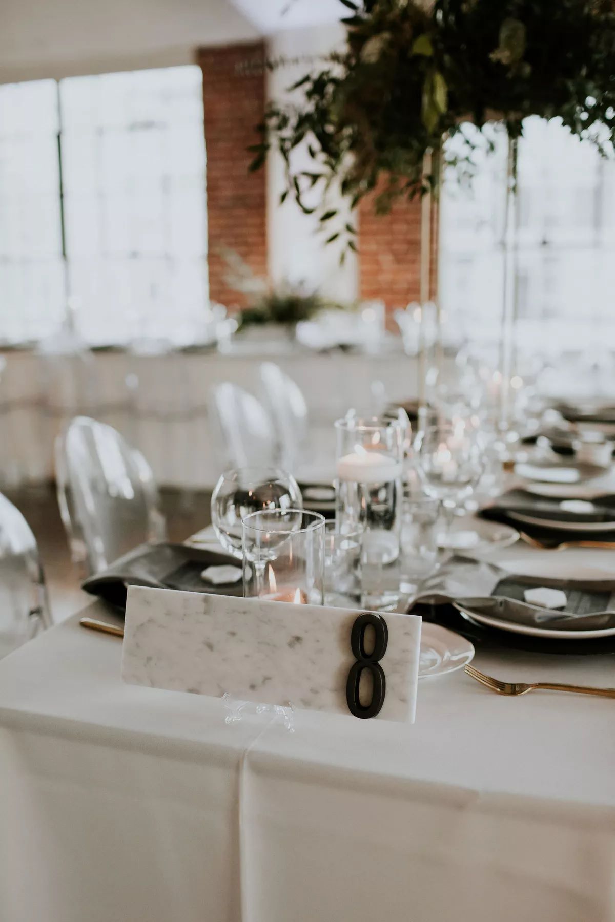 Back and white marble table numbers on wedding tablescape