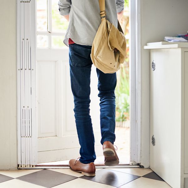 Bottom Half of Man in Jeans Walking Through Back Door of Home