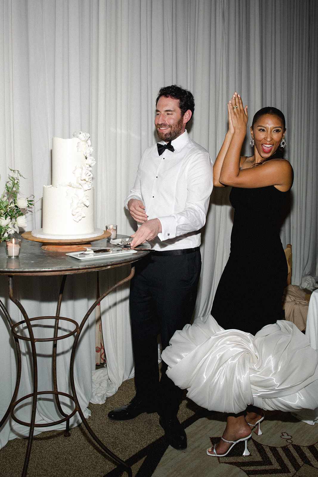 Couple Cutting Two Tier White Wedding Cake