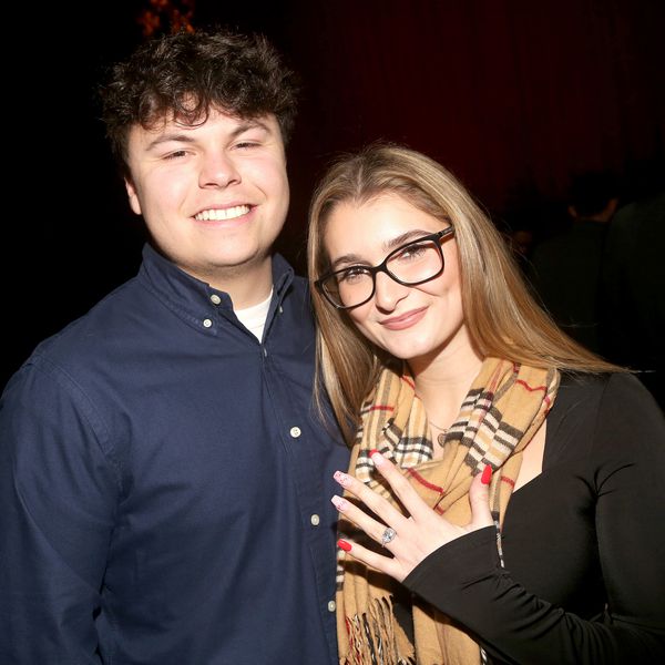 Blake O’Donnell Smiling With Teresa Garofalow Westervelt Who Is Holding Up a Diamond Engagement Ring 