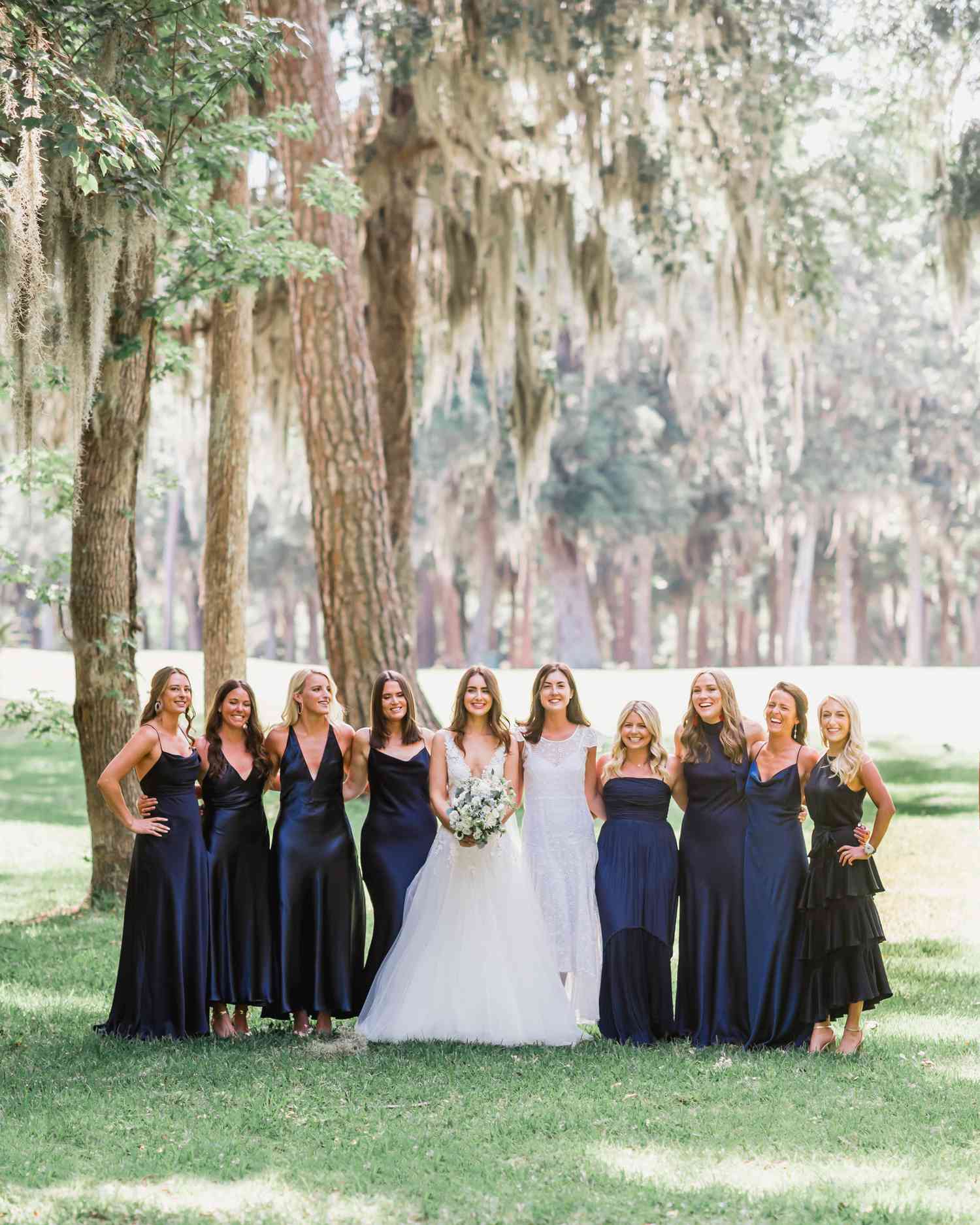 bride and bridesmaids wearing navy blue dresses