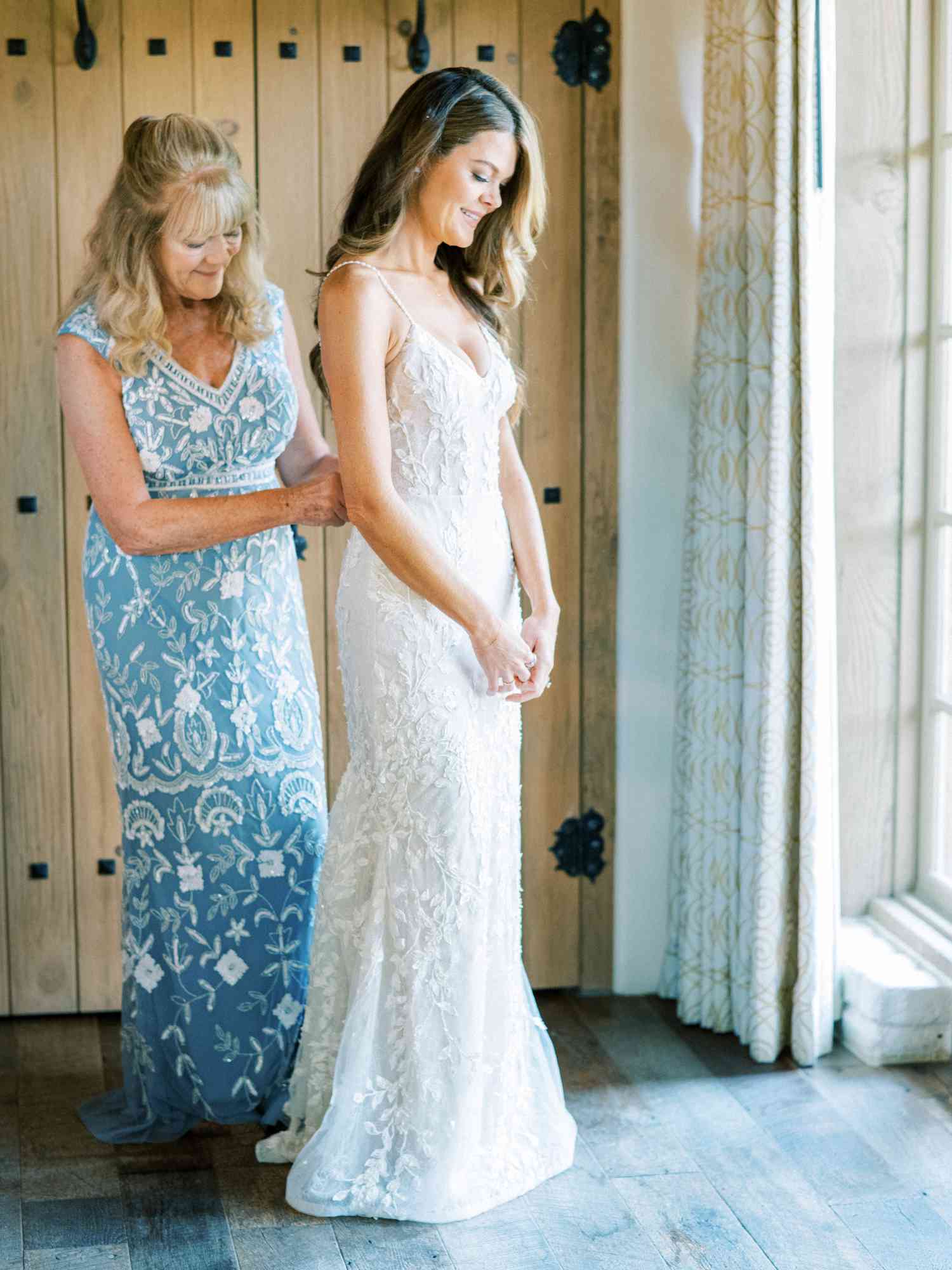 bride getting into wedding gown