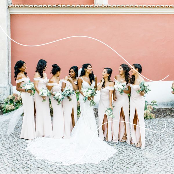 Bridesmaids in Pink Off-the-Shoulder Gowns with Bride in Wedding Dress Against Pink Wall