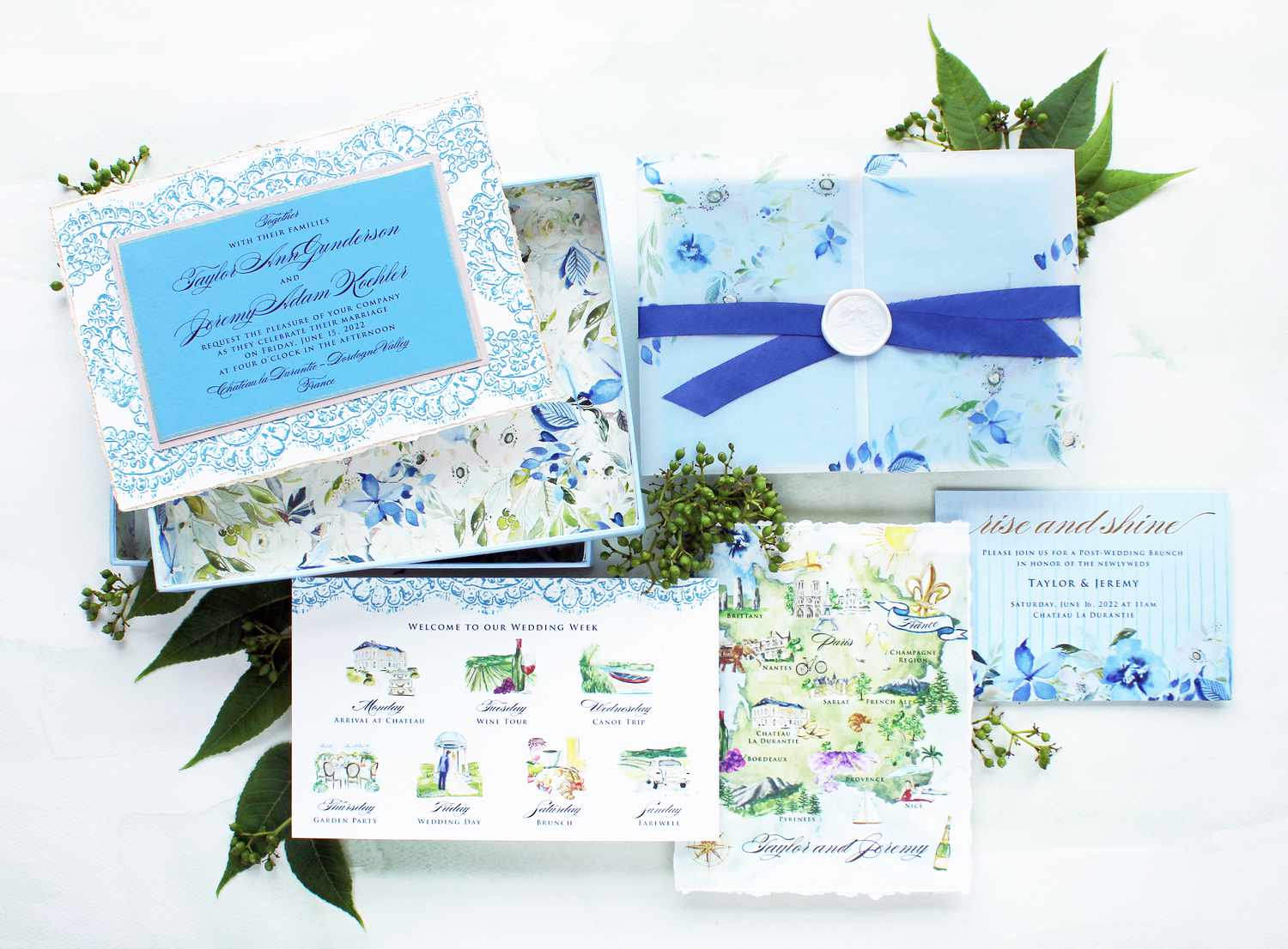 A blue illustrated boxed wedding invitation.