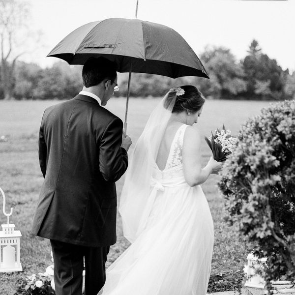 Bride and groom holding an umbrella