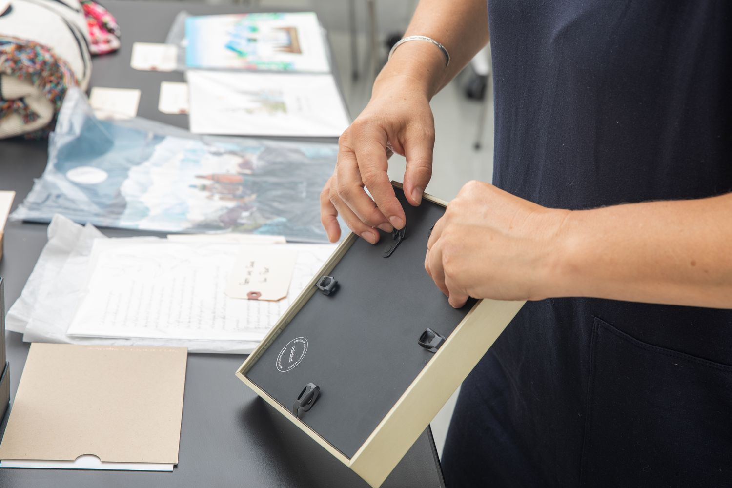 A person showing the back of the Minted Letterpress Vows Art Print.