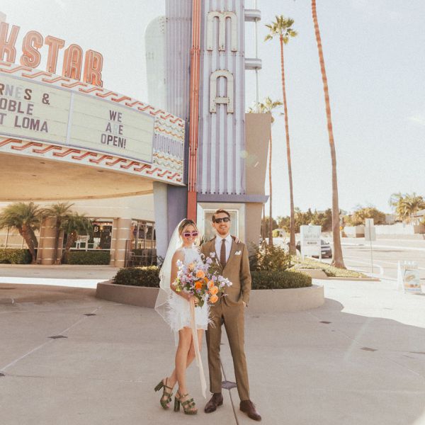 Bride and Groom Standing in Front of Old Theater