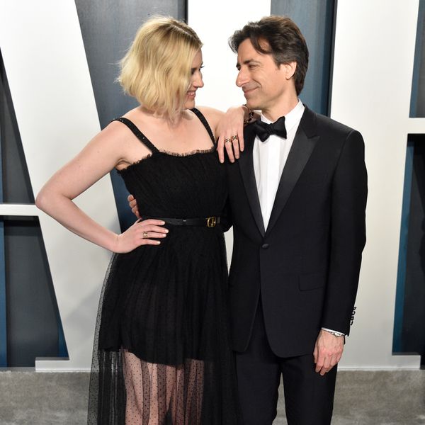 Greta Gerwig putting her arm on Noah Baumbach's shoulder at Vanity Fair Oscar Party