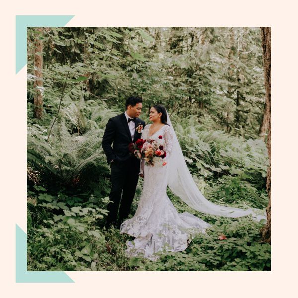 Bride and groom looking at each other amongst a bed of ferns