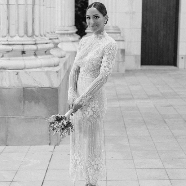 Bride wearing an embellished long sleeve mock neck wedding dress