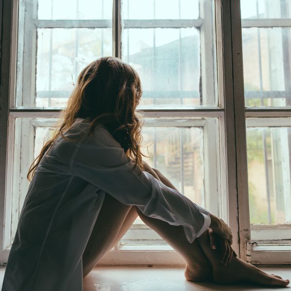 woman looking out window