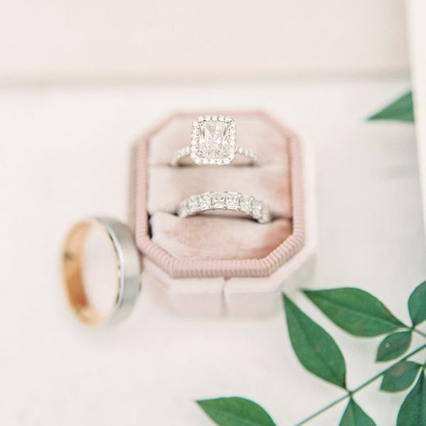 silver square engagement ring and diamond wedding band in a pink ring box