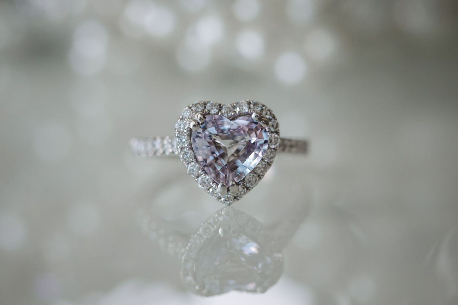 Heart-shaped engagement ring with diamond halo and diamond band