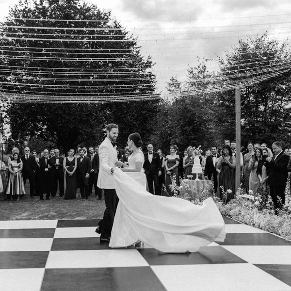 bride and groom having their first dance while guests watch