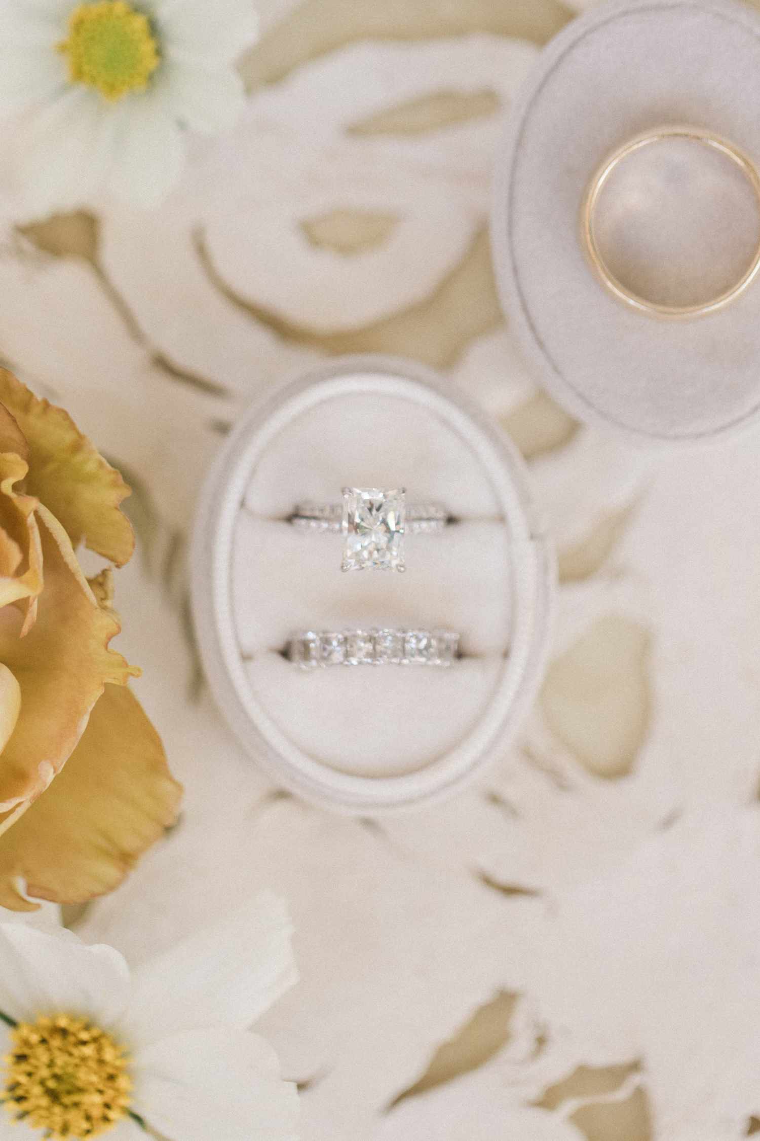 silver cushion-cut engagement ring in a tan ring box