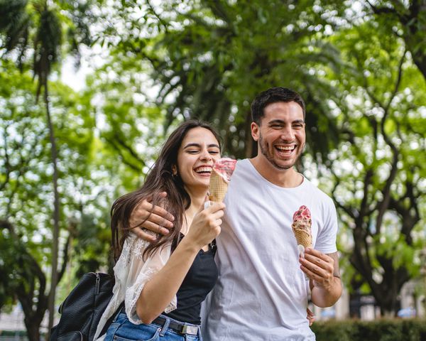 Couple eating ice cream while on a walk outdoors