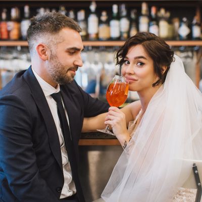 bride and groom sipping drink at bar