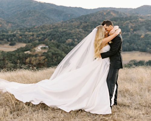 bride and groom hugging amongst a mountainous backdrop