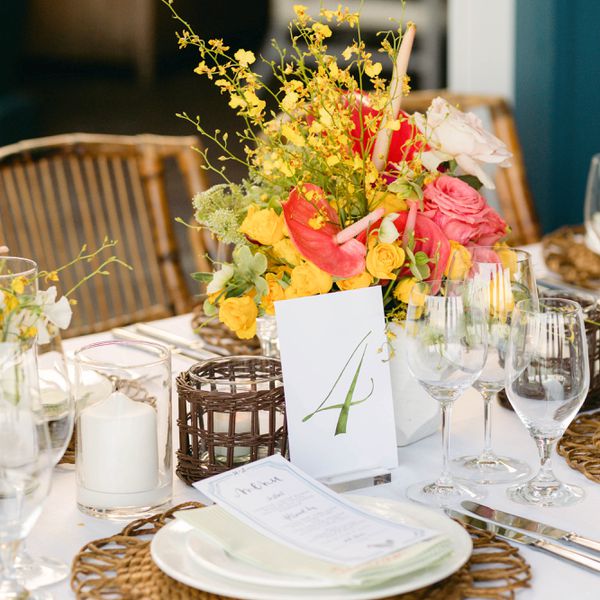 Reception table decor and menu with a citrus and pink color palette 