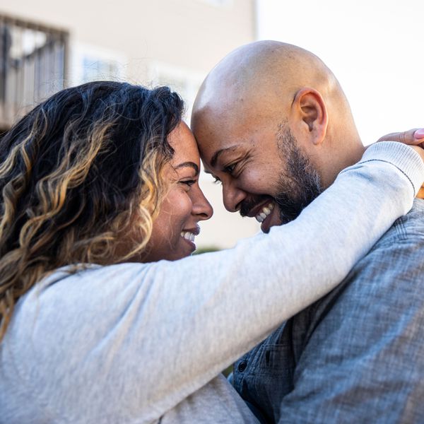 Woman and Man Looking into Each Otherâs Eyes and Embracing